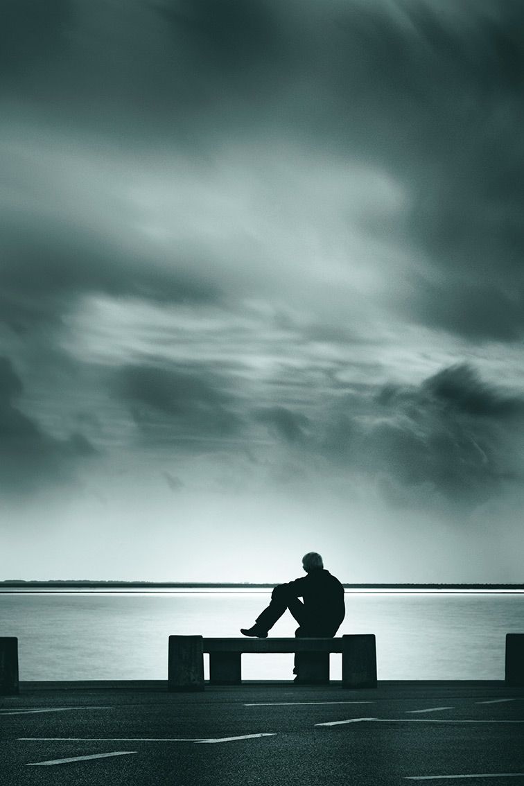 Lonely man admires the beautiful clouds and seascape