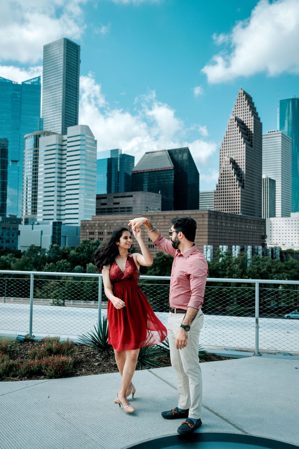 A couple shares a dance moment against Houston's iconic downtown skyscrapers.