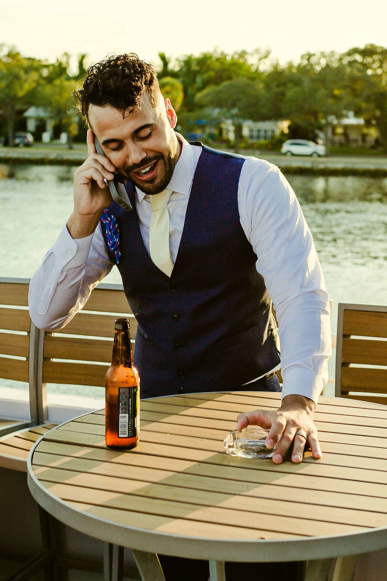 groom drinking and taking a phone call