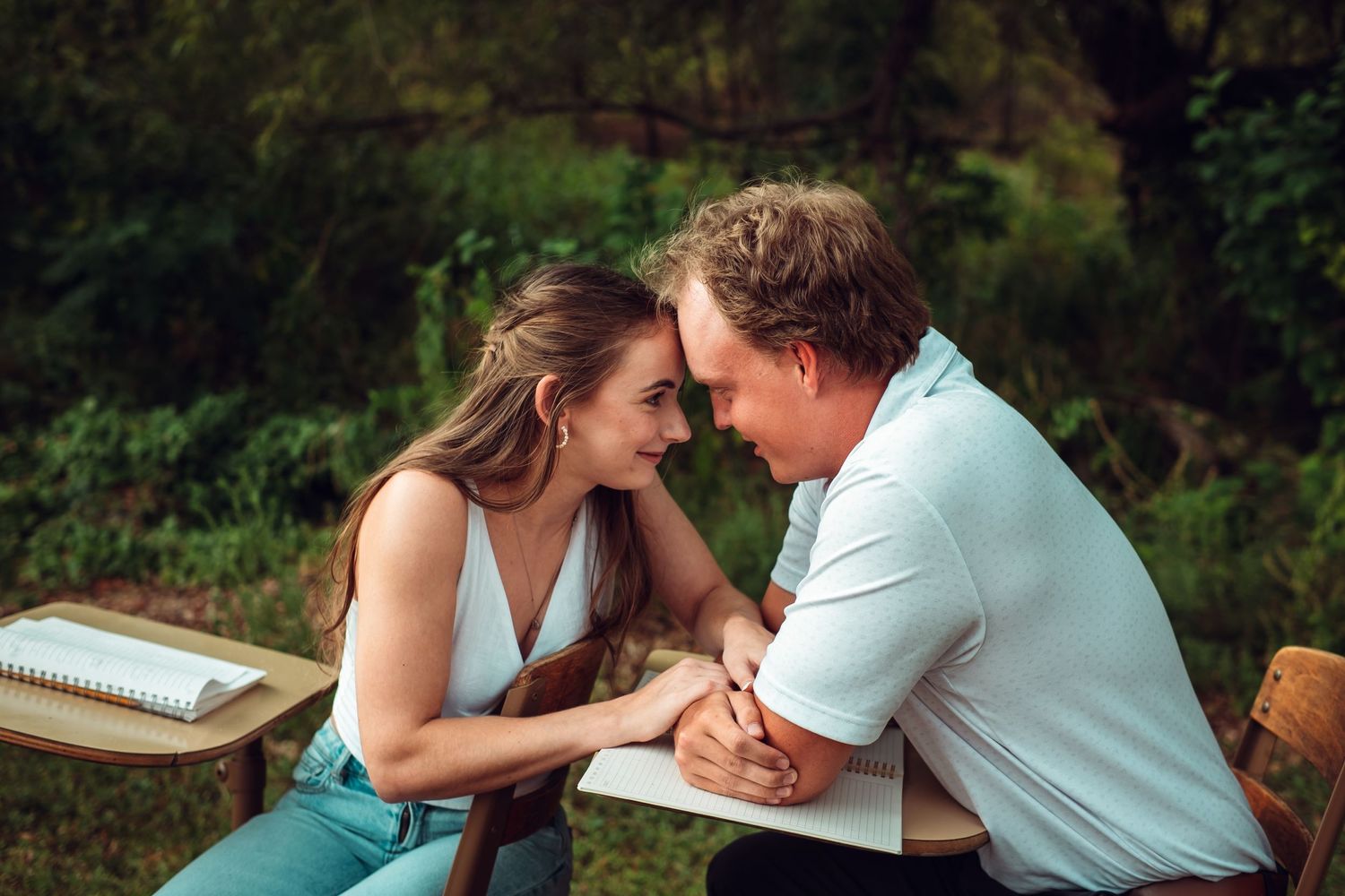 Romantic couple's photoshoot in a lush outdoor setting.