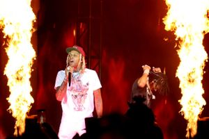 Concert performance with dramatic fire effects and pyrotechnics on stage.