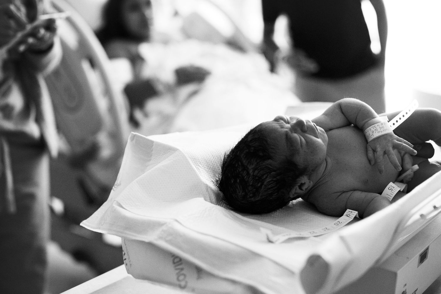 Newborn just after birth being weighed in the hospital.