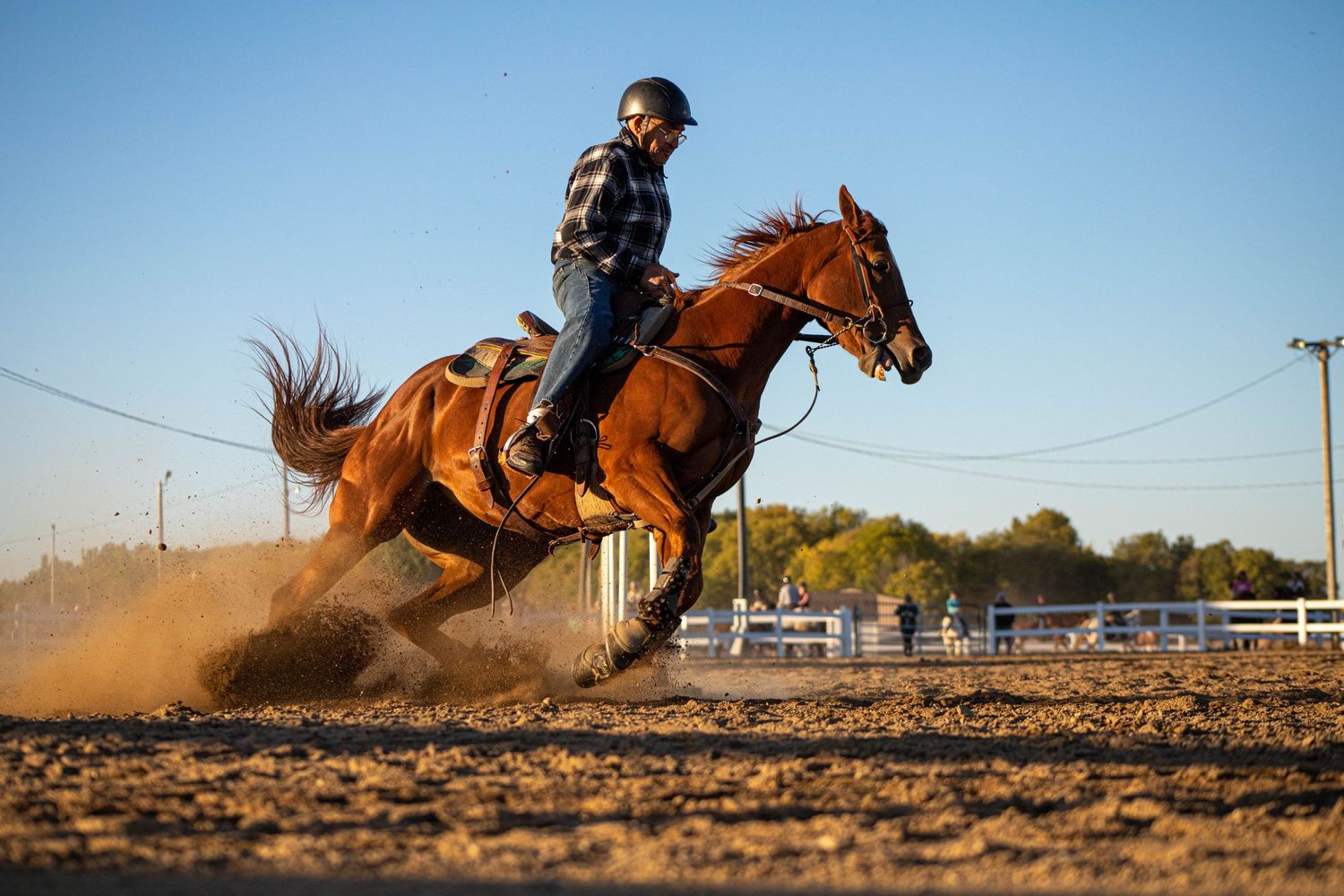 Series of action shots showing a horse and rider racing and turning at high speed in dusty arena conditions.