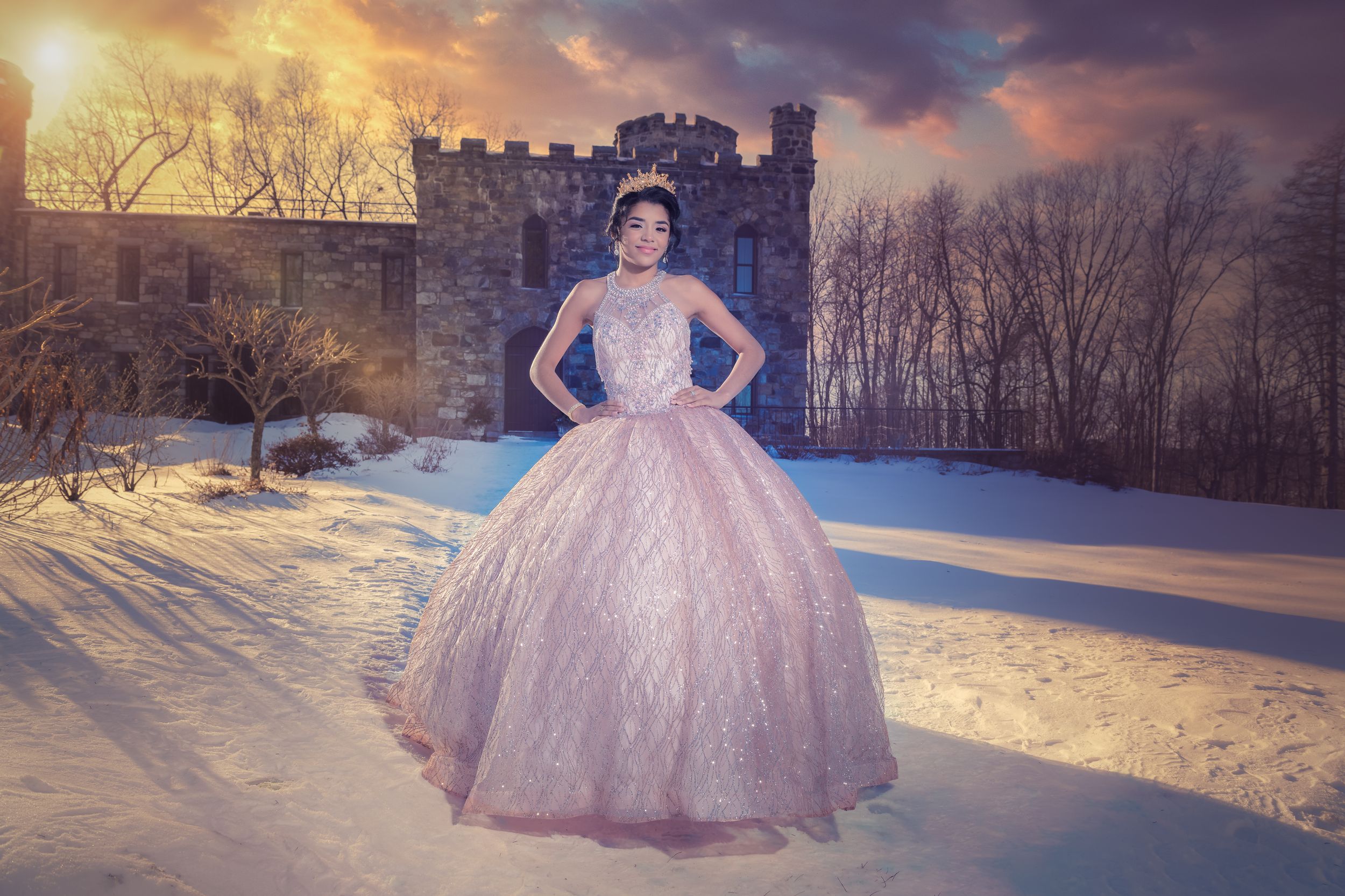 Pink ballgown photographed in a snowy winter landscape during golden hour.