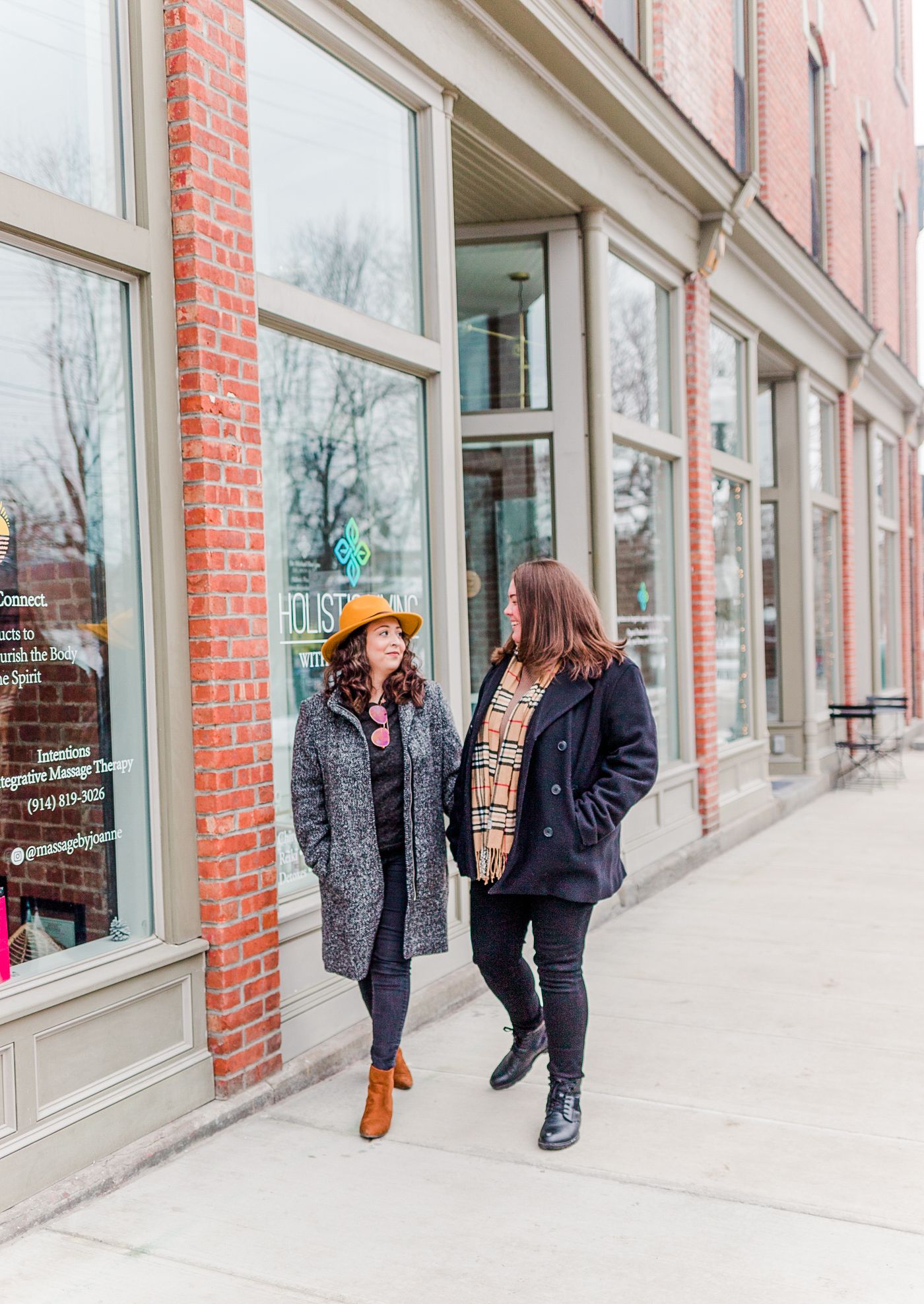 Same sex couple smiling and holding hands during an engagement session in Beacon, NY with Danielle Lauren Photography