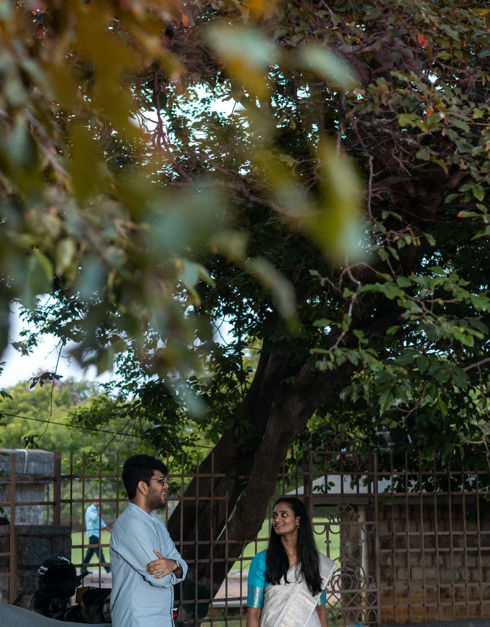 Autumn foliage frames a casual outdoor meeting scene.