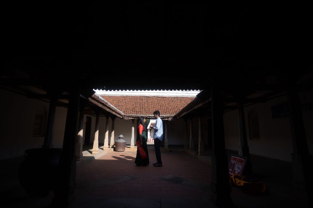 Silhouettes under covered walkway with dramatic natural lighting.