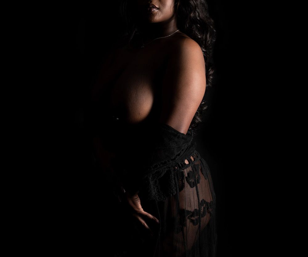 Low key portrait with sheer black lace details in shadows.