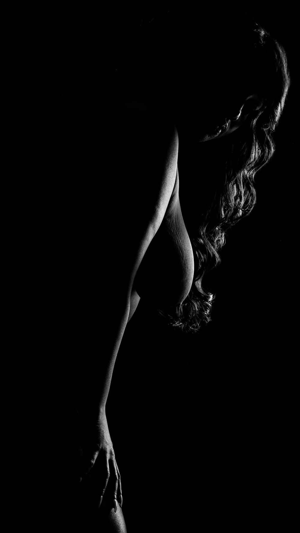 Artistic black and white side profile silhouette with flowing hair.