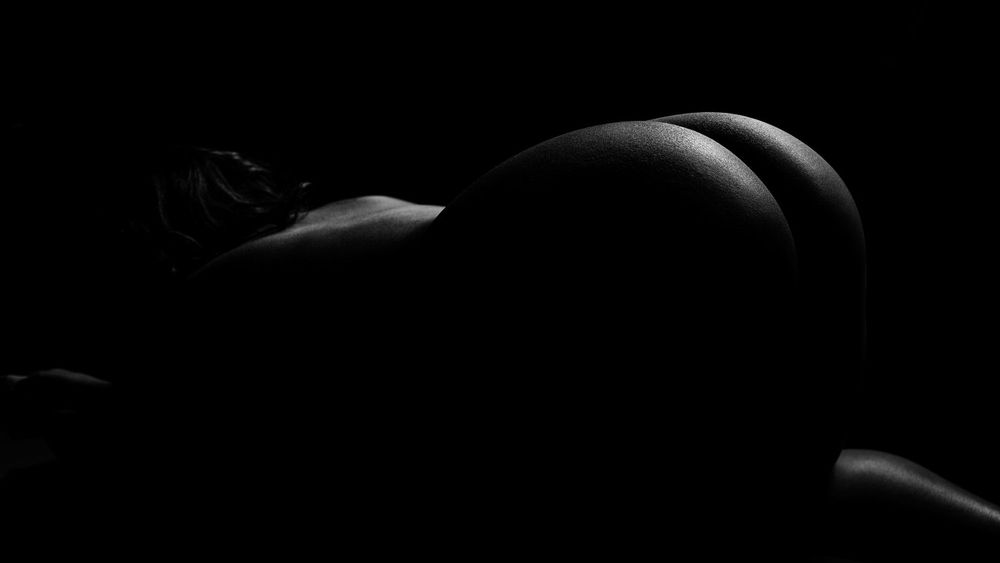 Artistic black and white photograph showing abstract curved shapes with dramatic shadows and highlights.