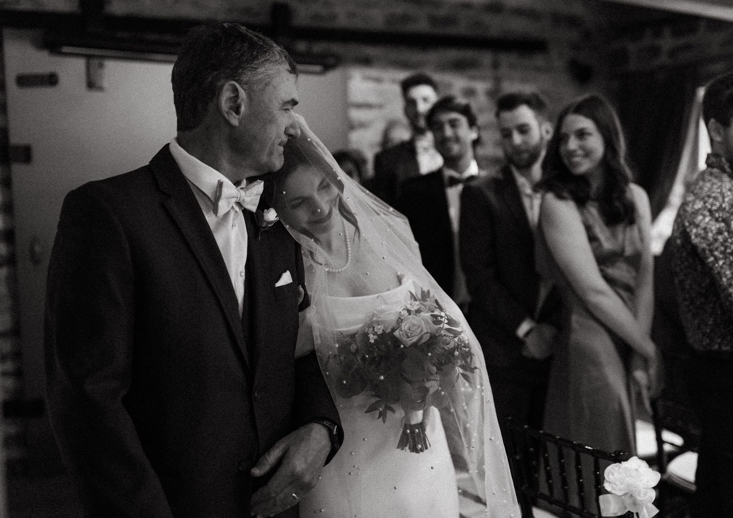 Emotional wedding ceremony moment captured in black and white photography.