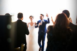 Celebration moment during wedding ceremony with guests in attendance.
