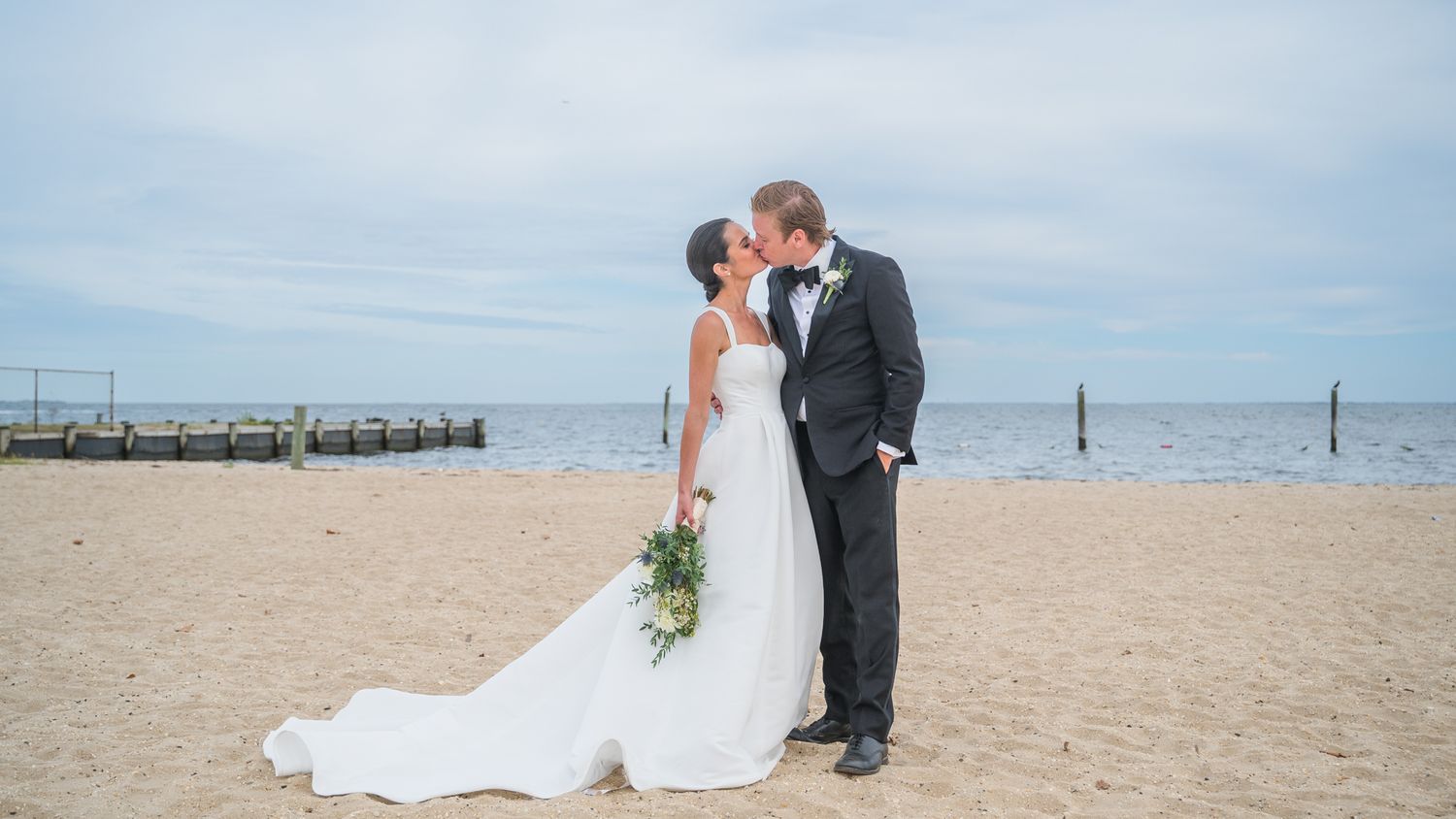 Couple kissing on a beach in Babylon, NY. Great wedding photo location.