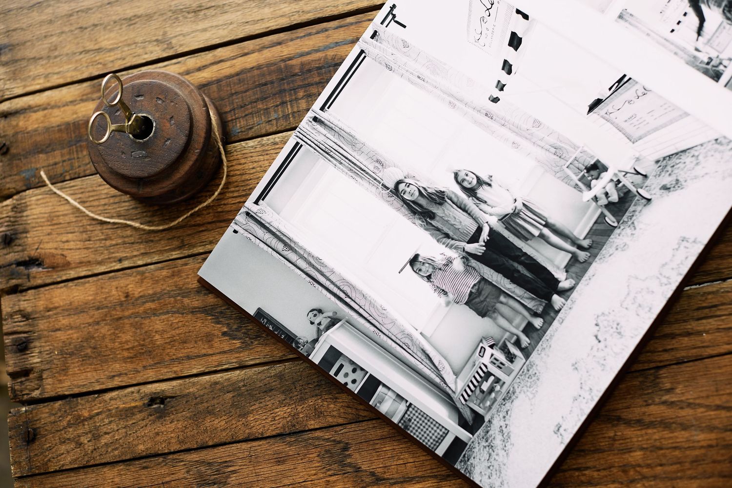 Vintage photographs arranged on a rustic wooden table surface.