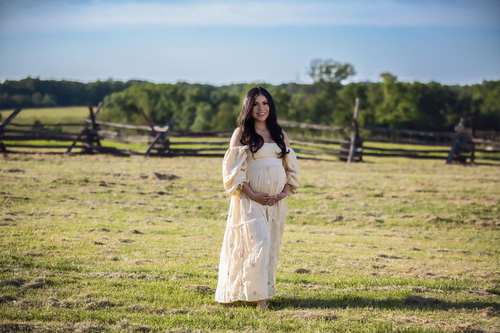 A dreamy countryside photoshoot with couples posing in an open field during golden hour.