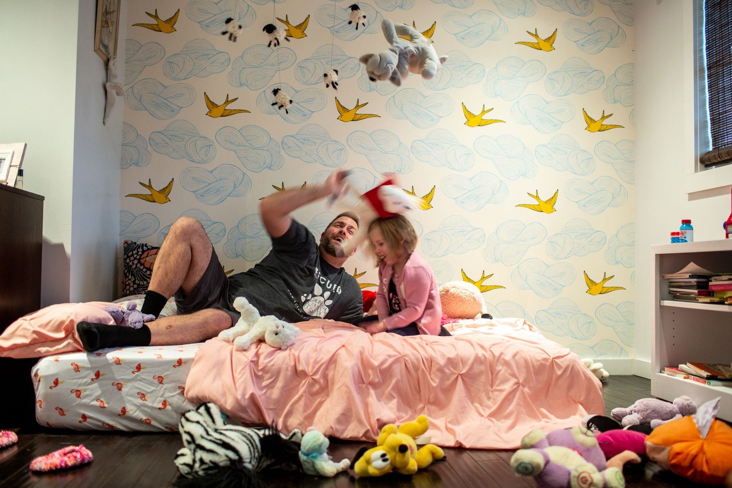 Playful nursery room scene with decorative yellow birds on light blue walls.