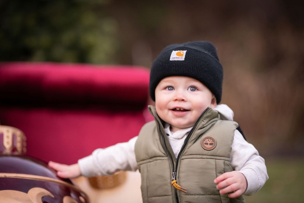 Candid winter outdoor portrait session with festive holiday decorations.
