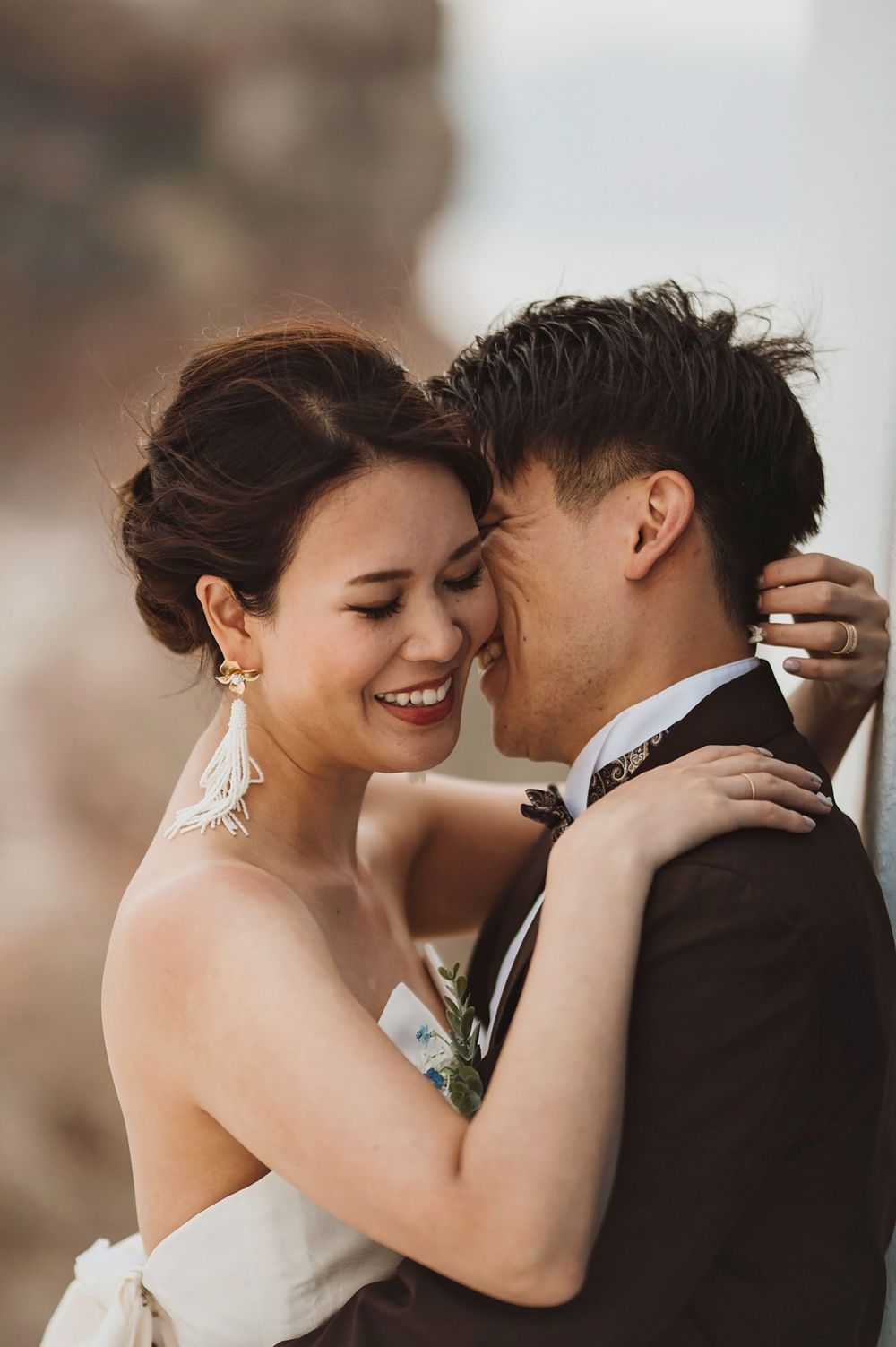 Intimate moment between newlyweds sharing laughter during their mountain wedding photoshoot.