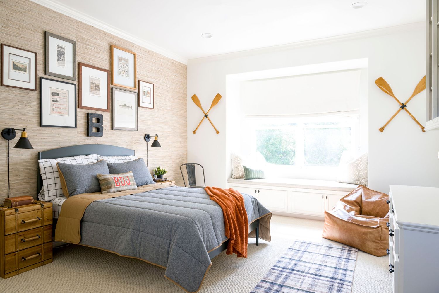 Coastal-inspired bedroom with paddle decor, gallery wall and blue bedding. Interior Design, NJ Photo