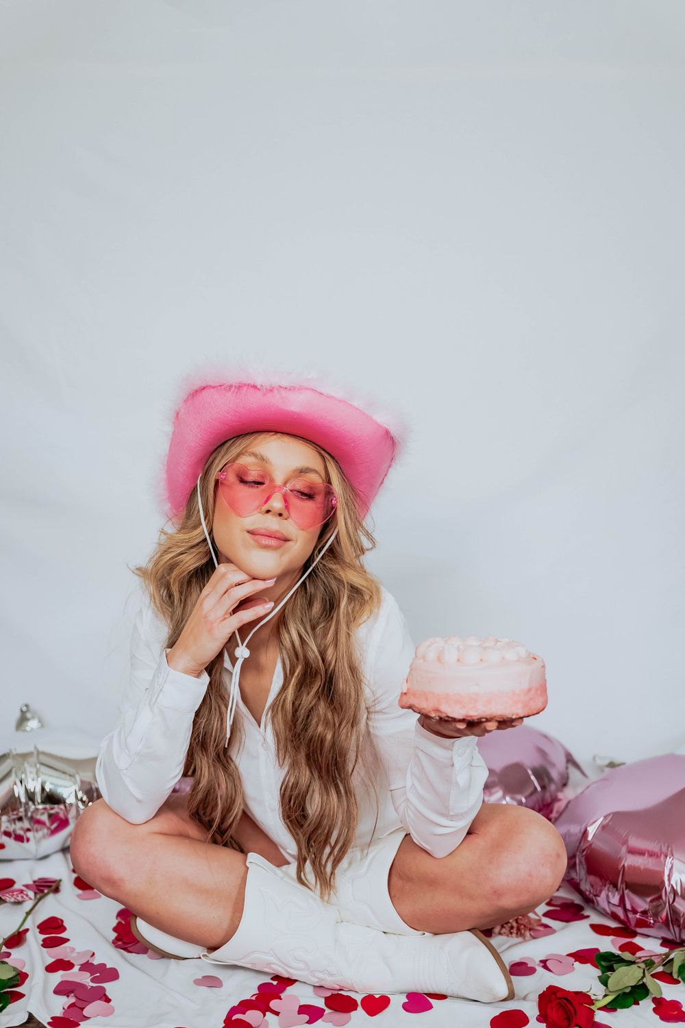 Whimsical photo series with pink theme featuring tea party setup and pink cake on white background.