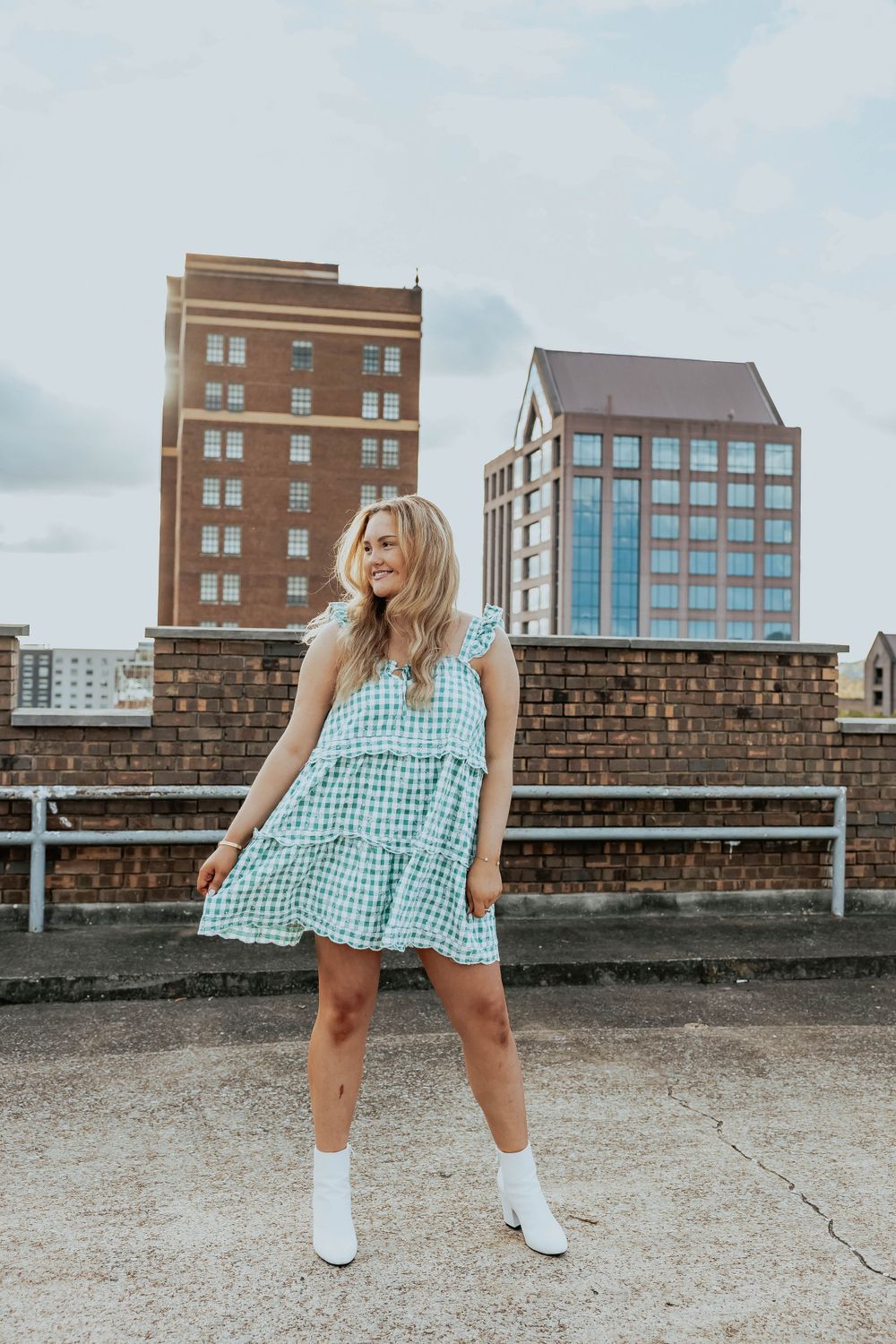 Urban rooftop fashion shoot featuring a blue gingham dress and white knee socks.