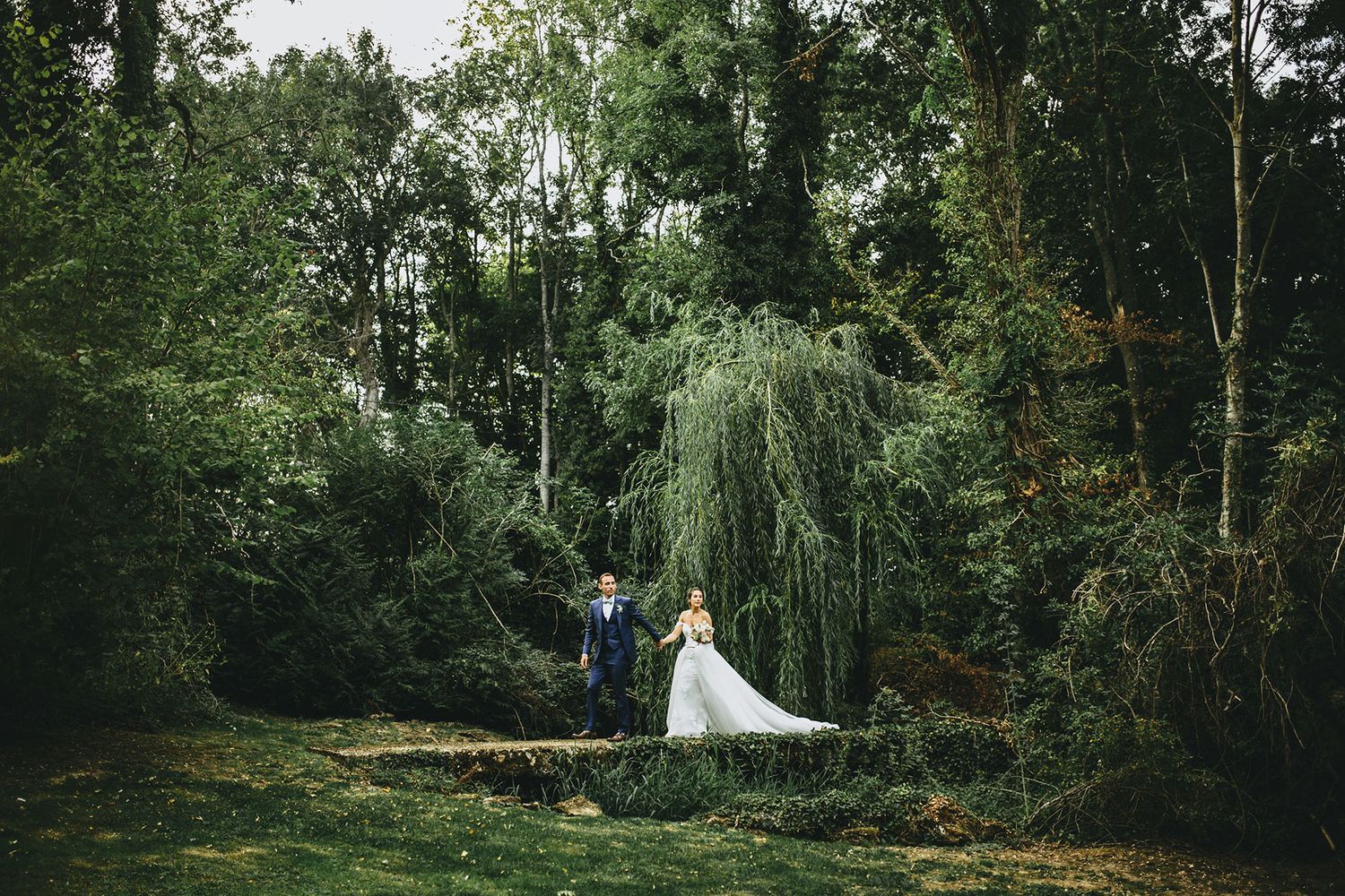 Enchanted forest wedding venue with natural greenery and white decor.