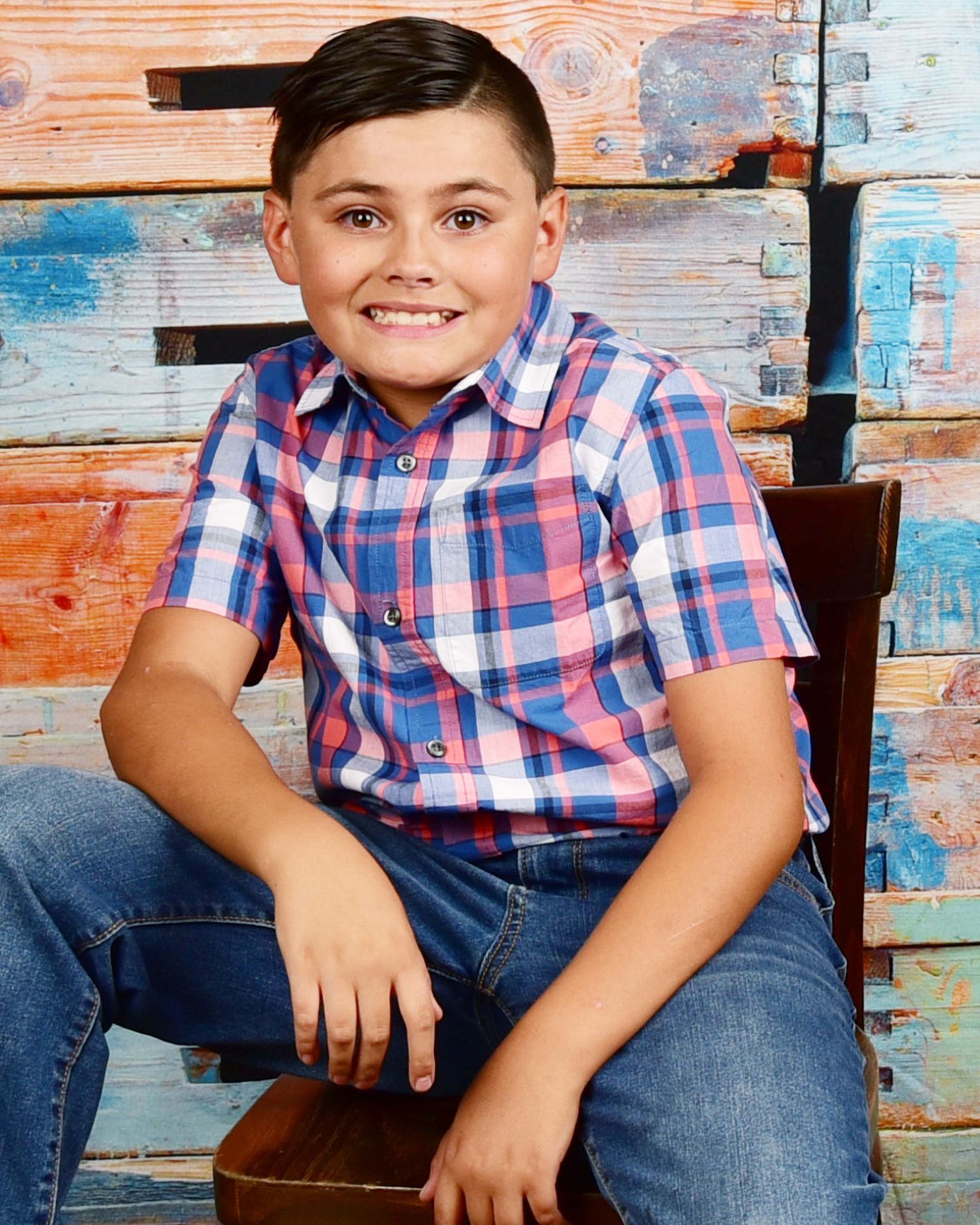 Portrait against weathered blue and orange wooden background.