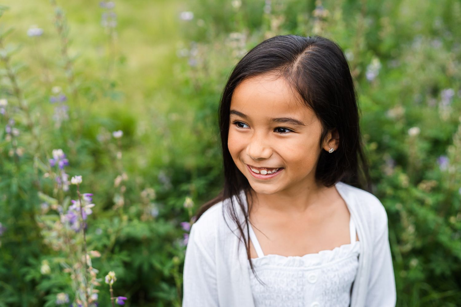 Smiling portrait of daughter among the Juanita Bay lupines