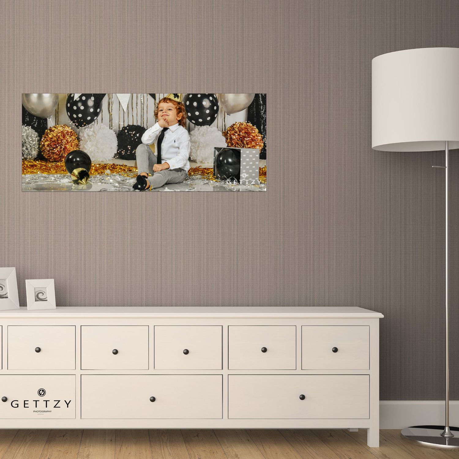 Canvas print of photograph displayed above white dresser with floor lamp in corner.