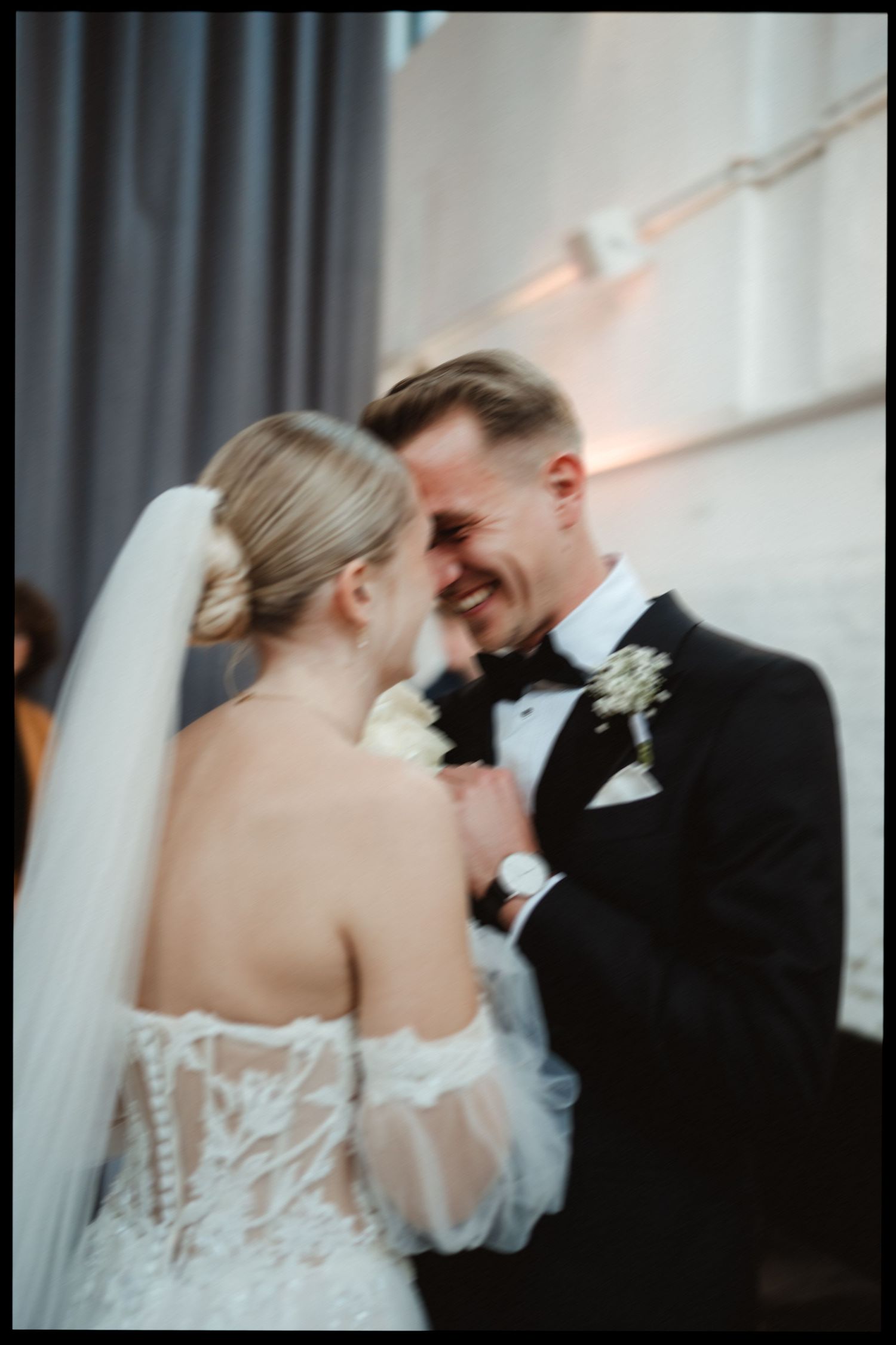 Intimate candid moment between newlyweds sharing laughter.
