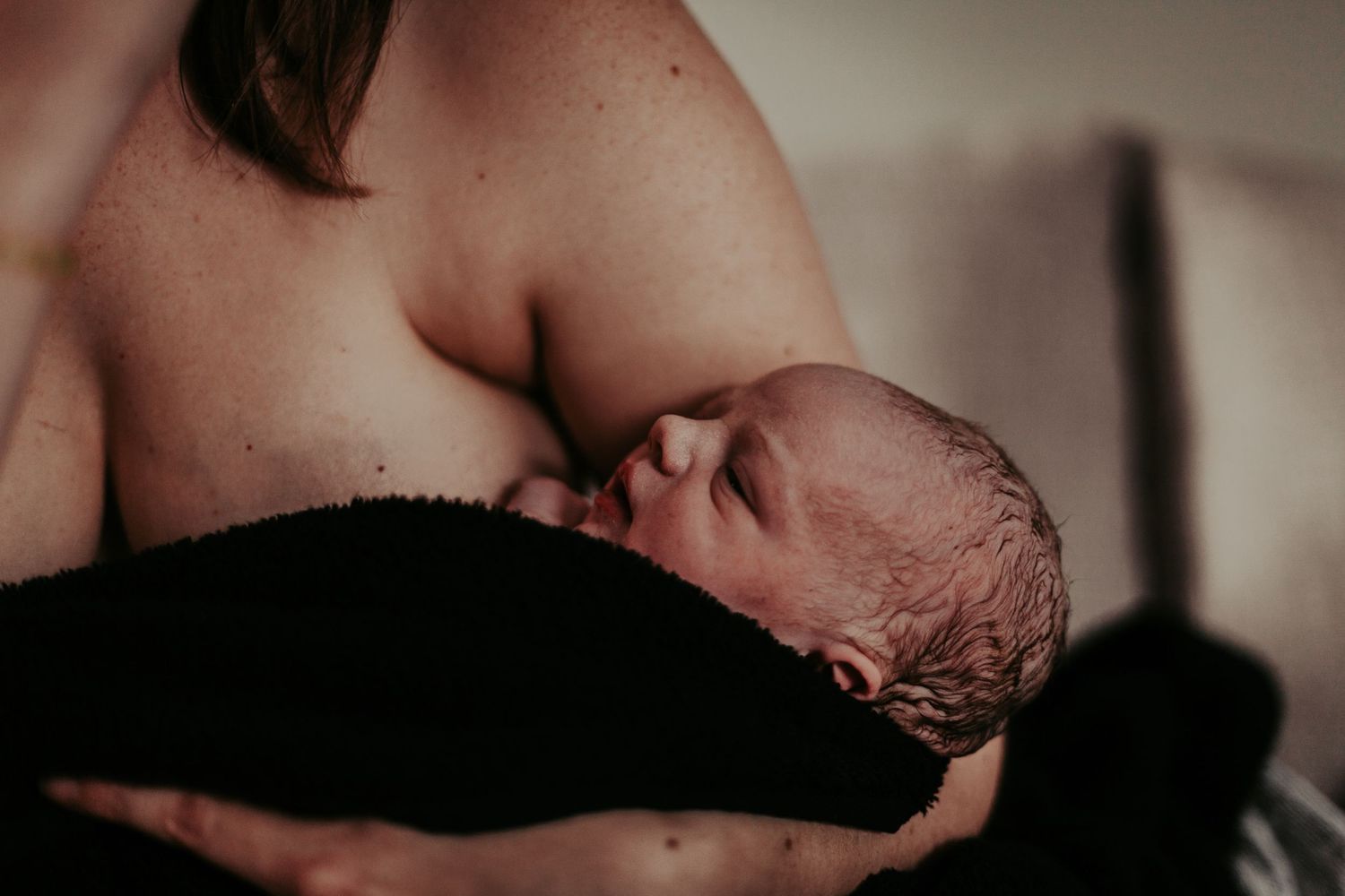 Newborn baby being held by mother