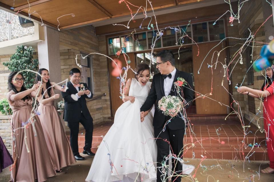 Bride and groom exit after nuptial mass at Sacred Heart Church