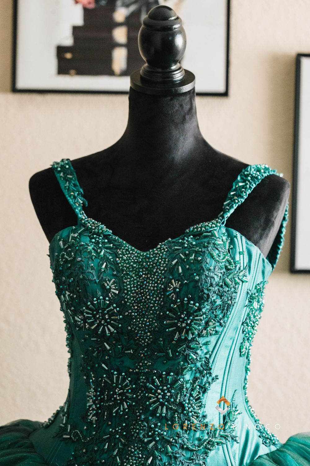 Emerald green ball gown bodice on black mannequin with intricate beaded details and sweetheart neckline.