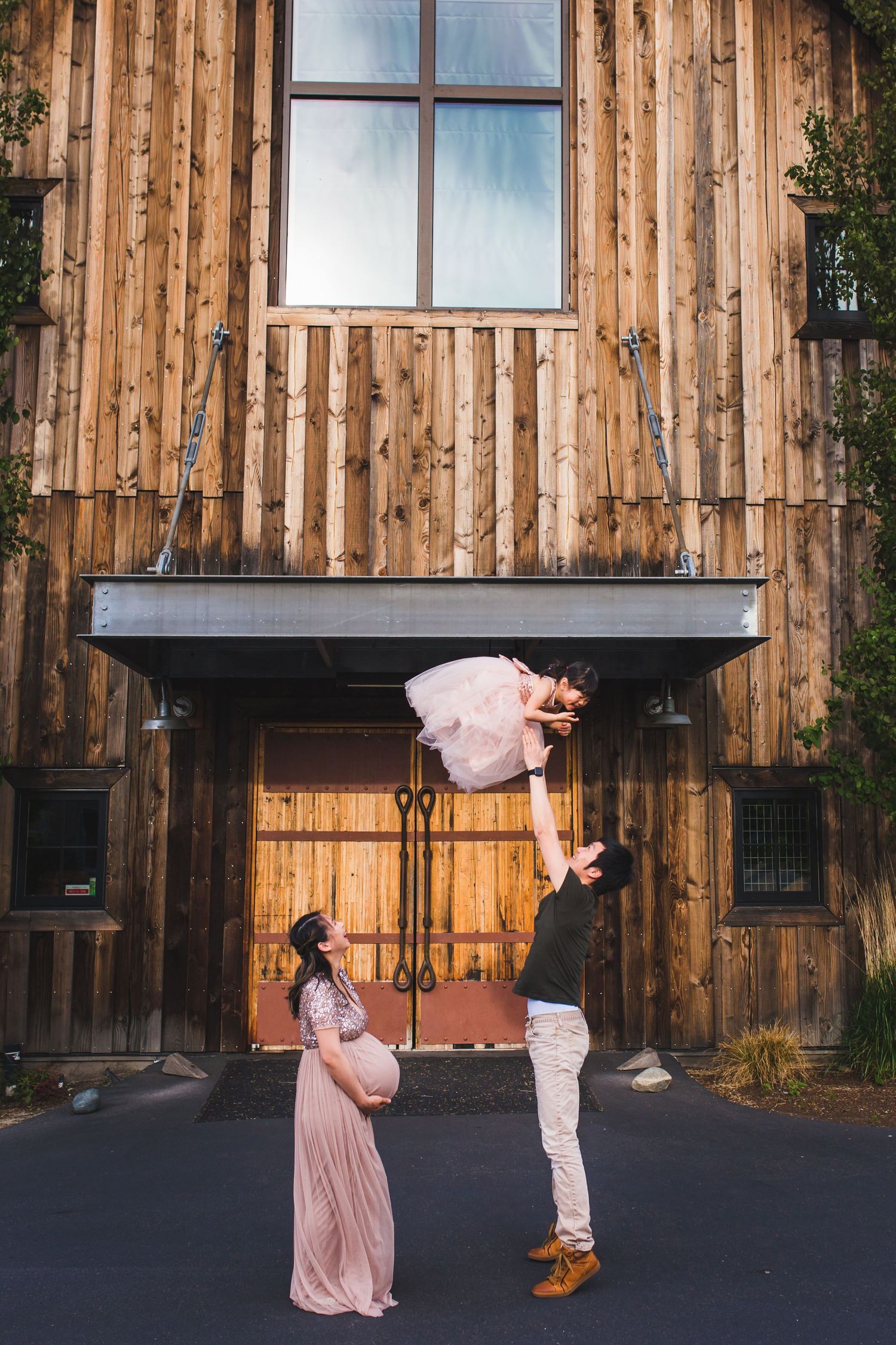 Best Redmond Family and Maternity photographer, throwing girl in air, lifestyle, candid, matching dresses