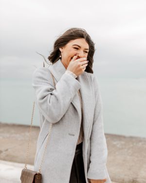 A joyful reaction captured during a surprise proposal by Lake Michigan.