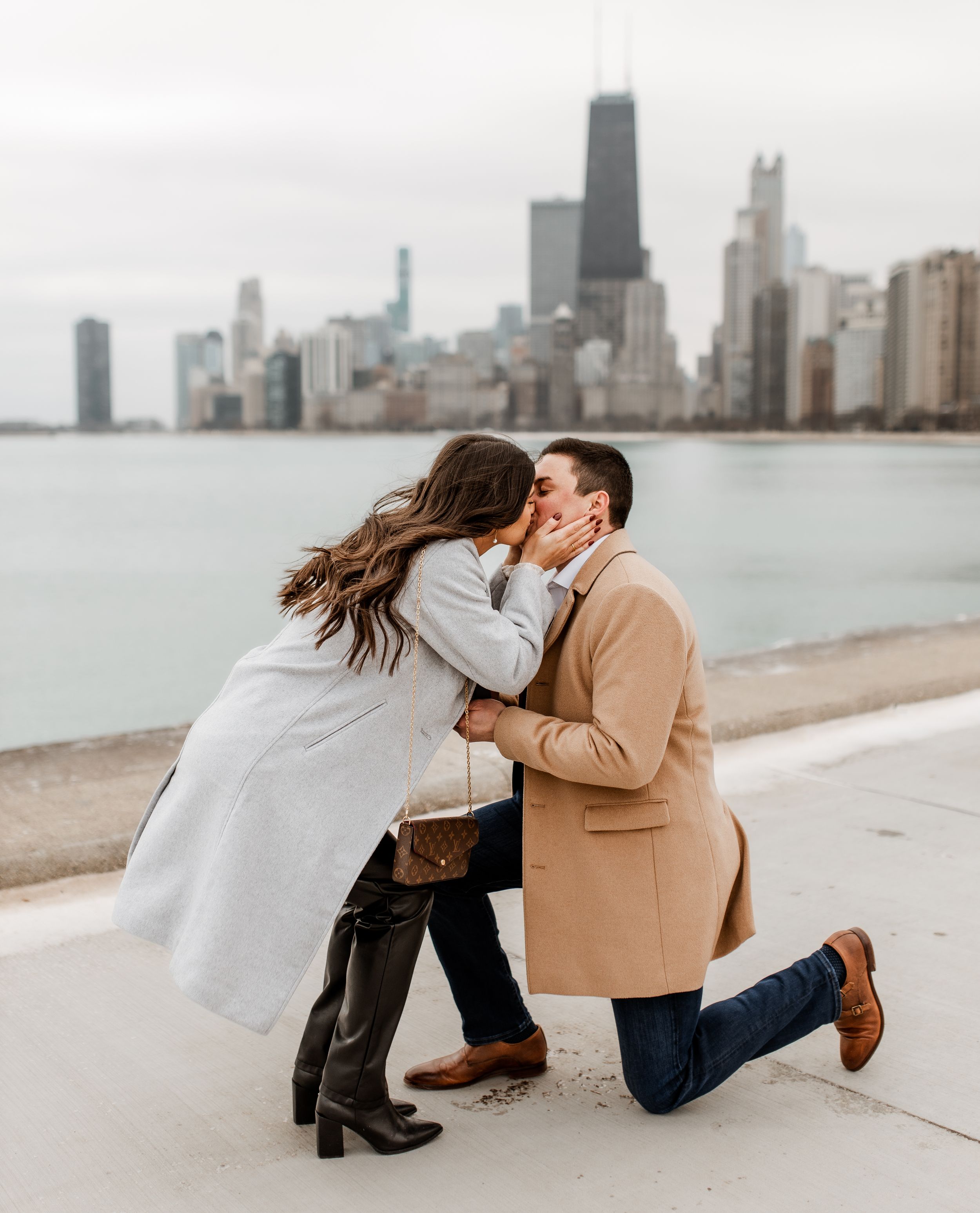 A tender proposal moment unfolds along Chicago's waterfront with the city skyline in view.