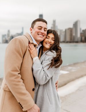 A happy couple shares an intimate moment along Chicago's lakefront path.