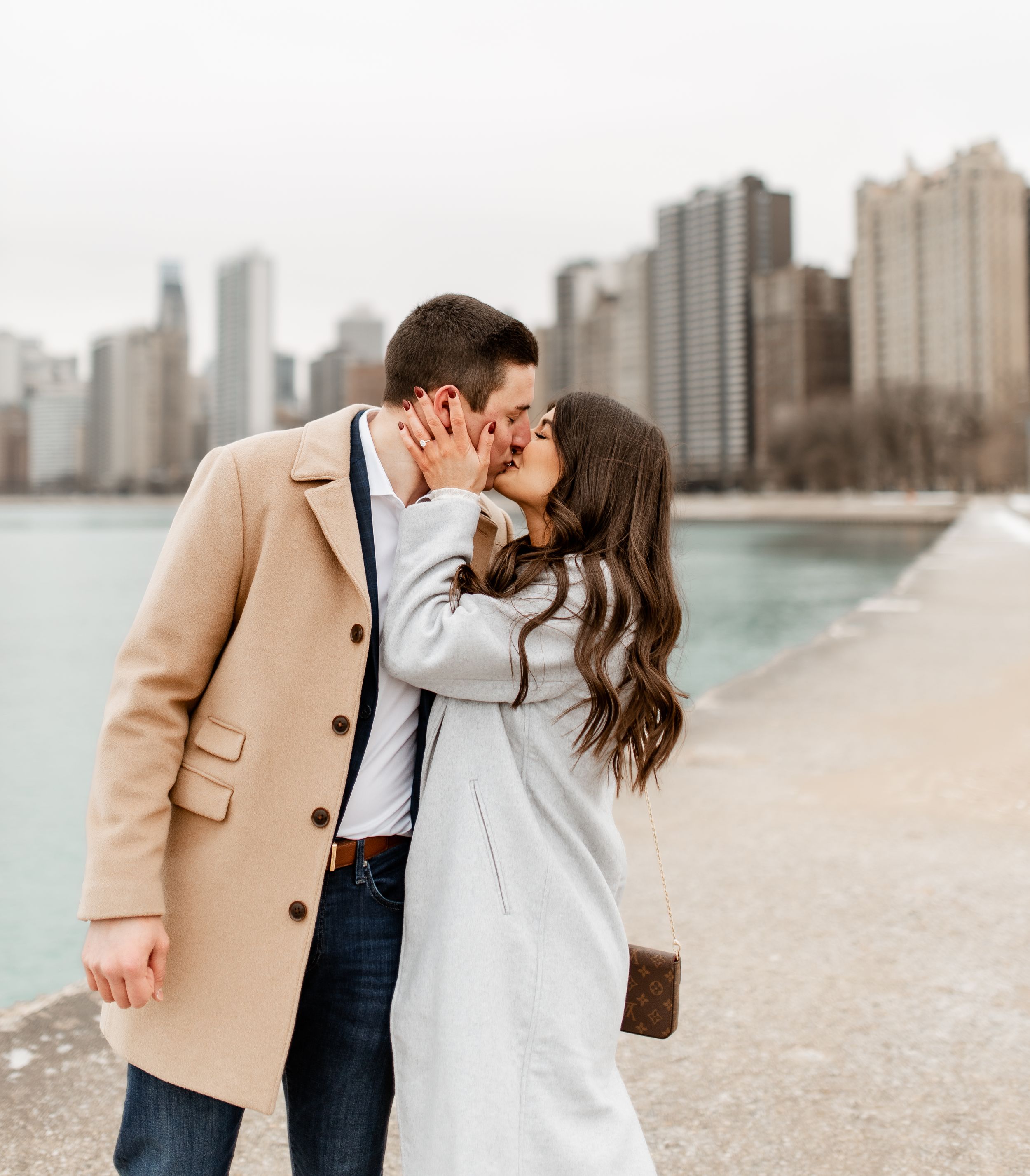 A romantic kiss shared between a couple on Chicago's waterfront walkway.
