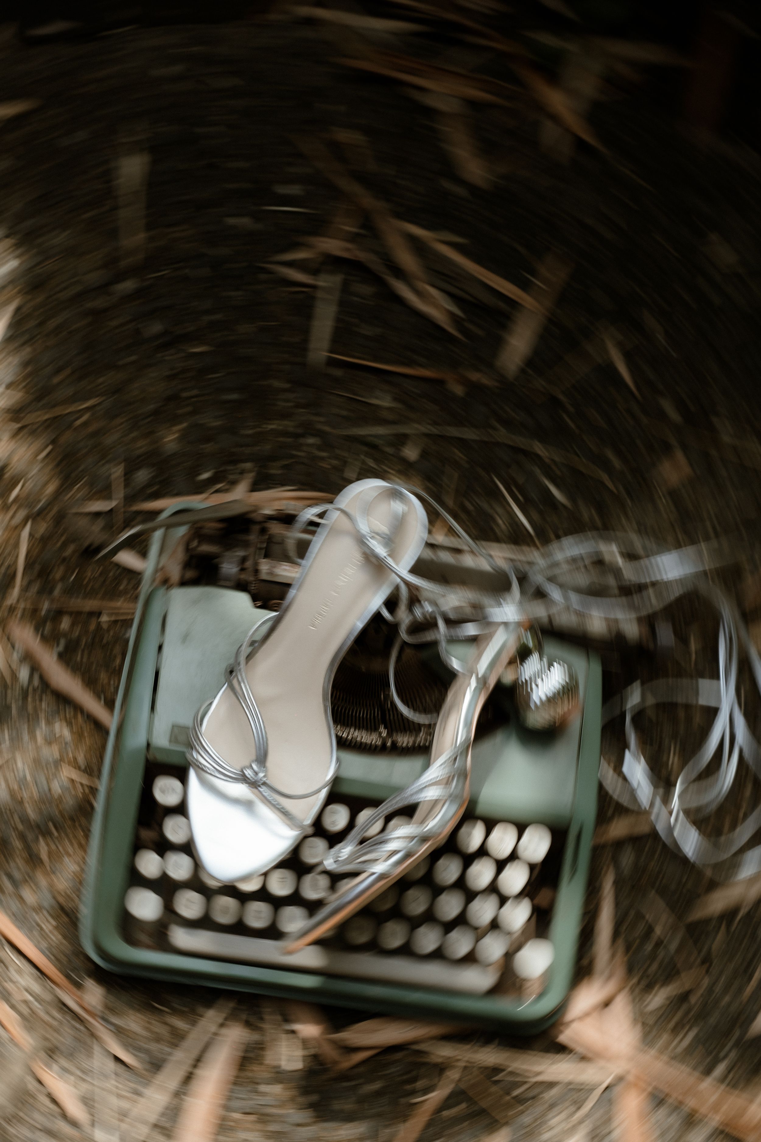 Vintage mint green typewriter photographed with artistic blur effect.