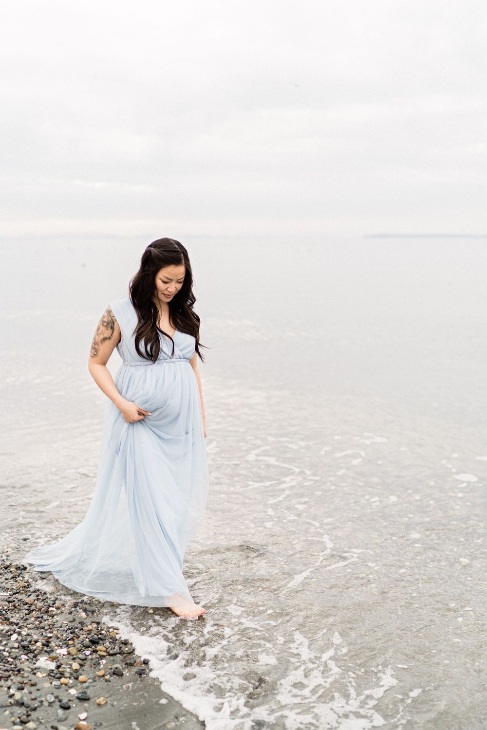 pregnancy on the beach wading through water