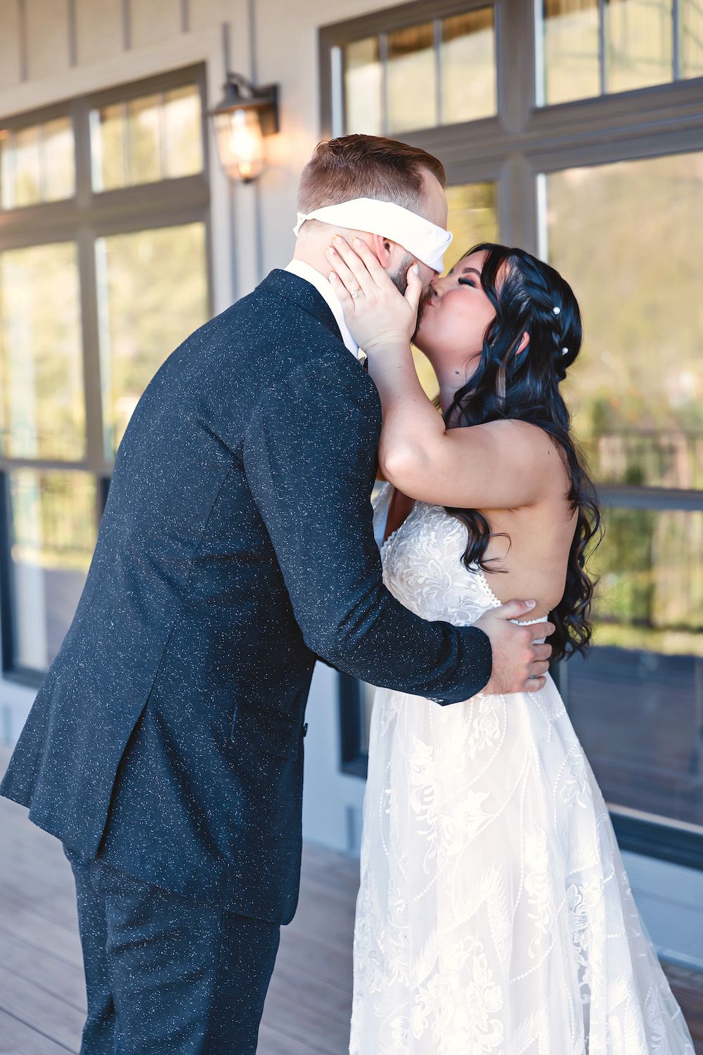 Blindfold groom and bride kissing at wedding in Summit County Colorado