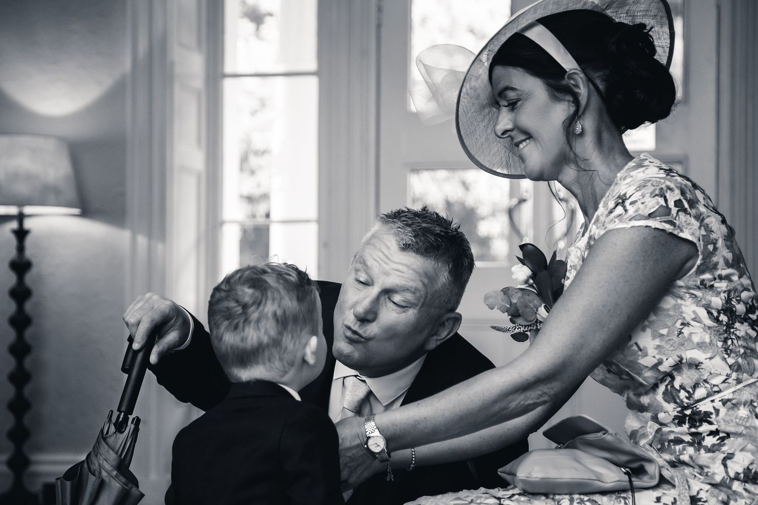 A black and white capture of a special moment between three people during a formal event.