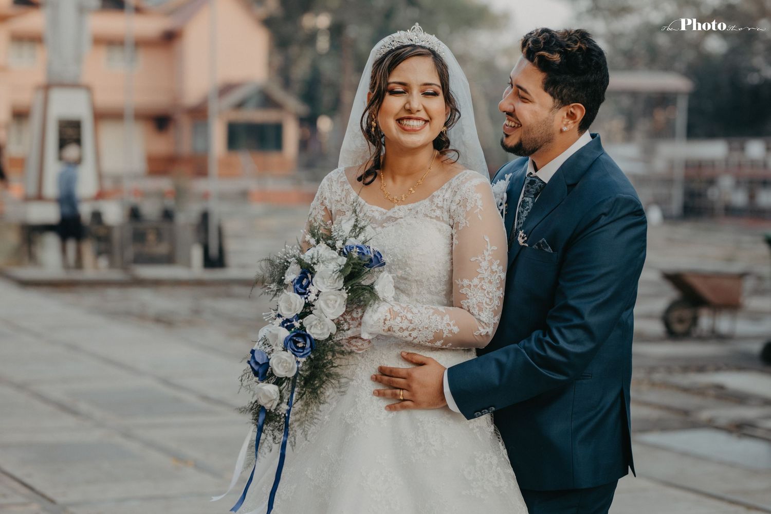 Newlyweds share intimate moment during outdoor wedding photoshoot.