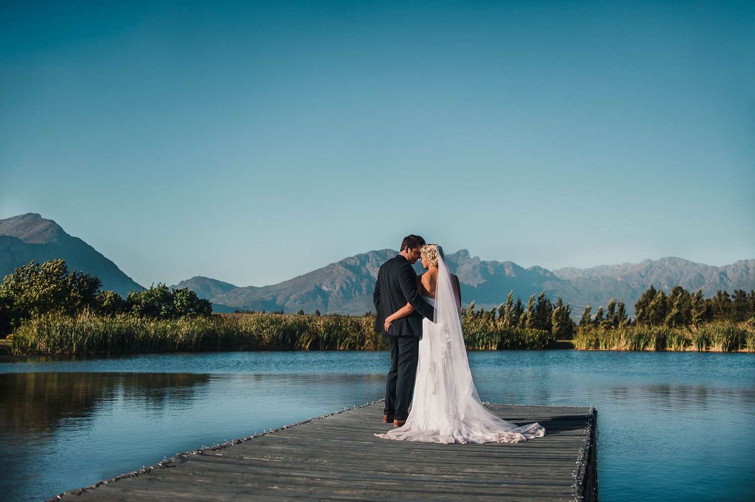 Bride and groom on the dock of the dam