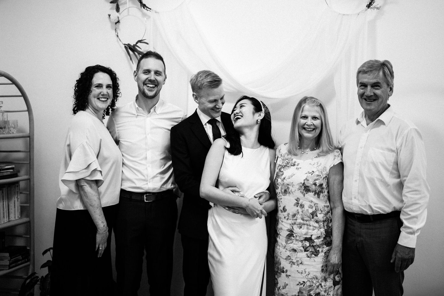 Group celebration photos in black and white showing natural reactions and smiles.