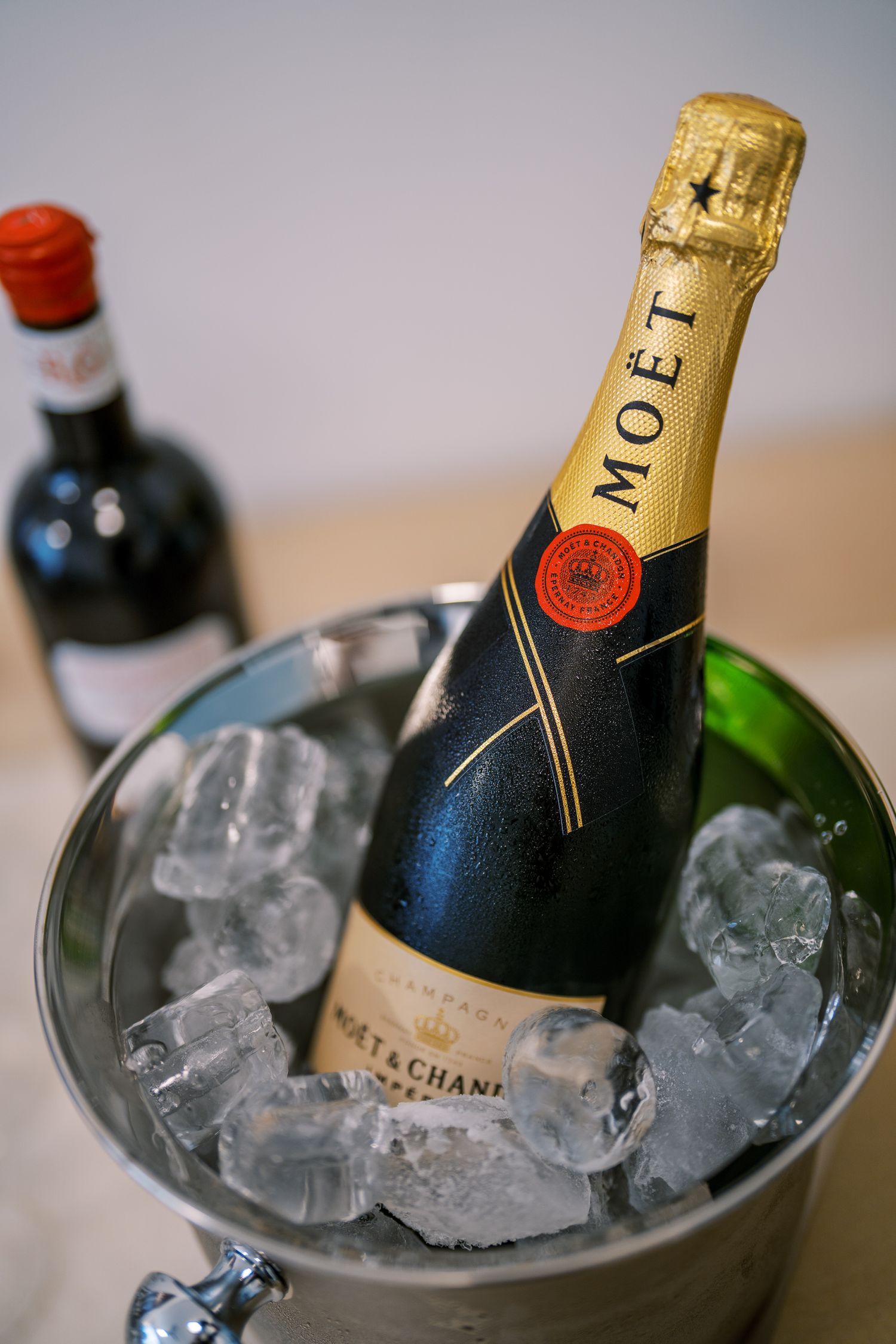 Champagne bottle chilling in ice bucket at celebratory event.