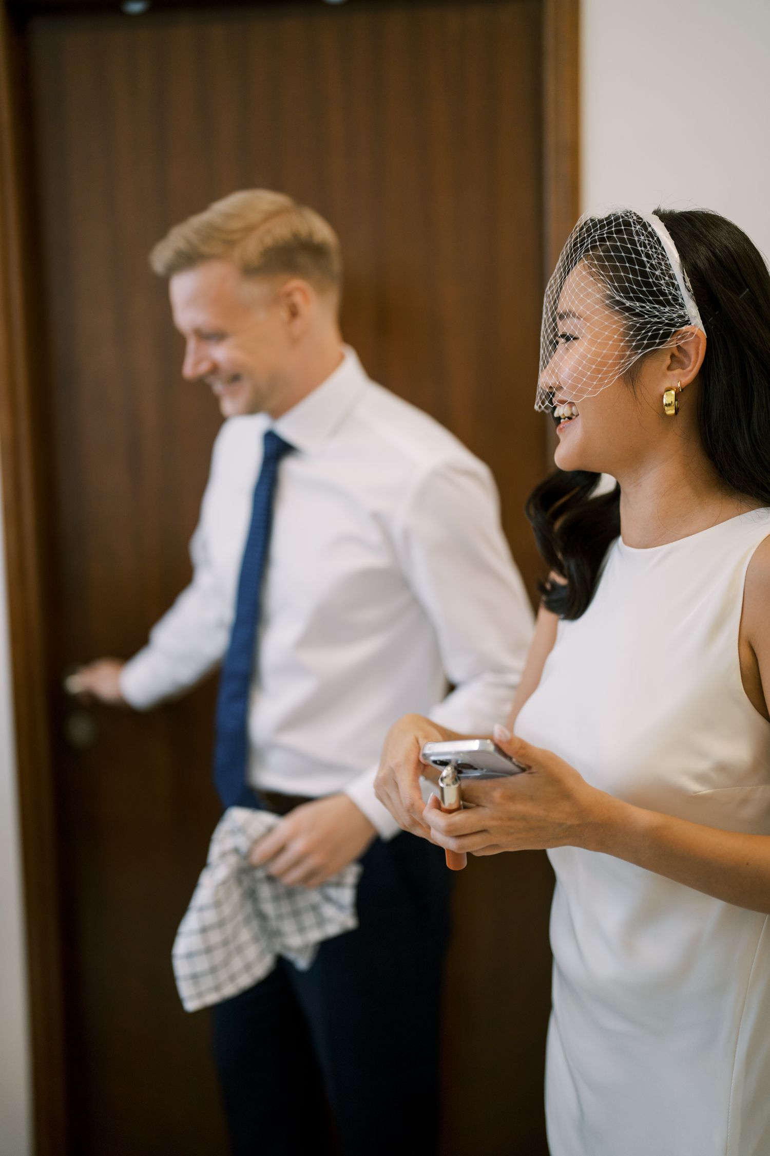 People in formal attire interacting during a wedding celebration.