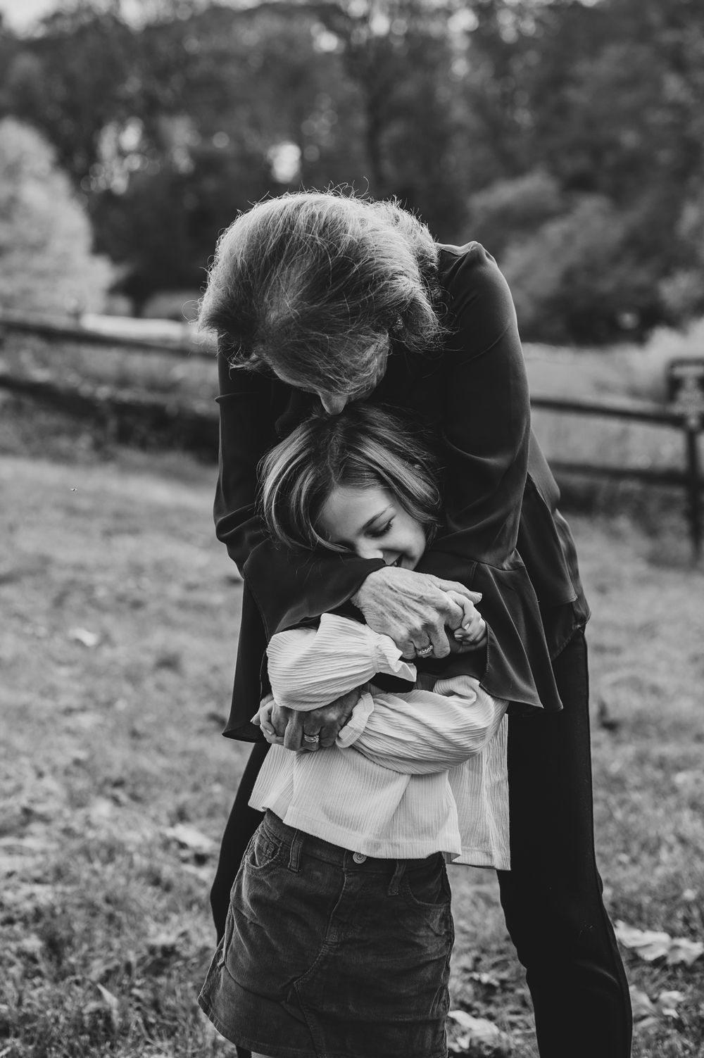 Black and white intimate moment captured during outdoor family photoshoot.