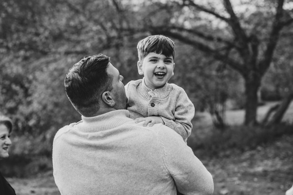 Candid moments of laughter and joy during an outdoor family photography session.