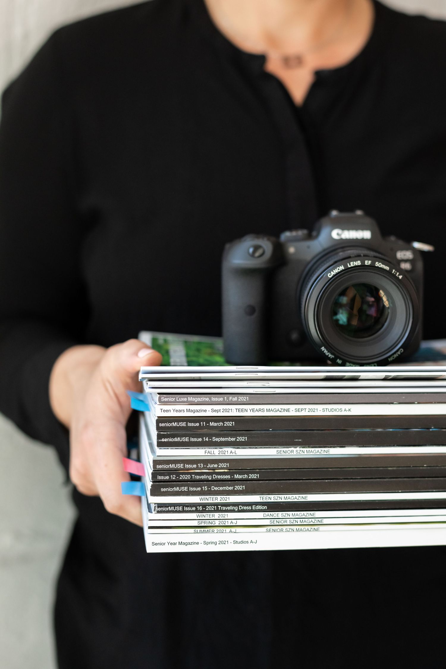 Aly Darin holding senior photography magazines and camera. Beverly Hills, MI